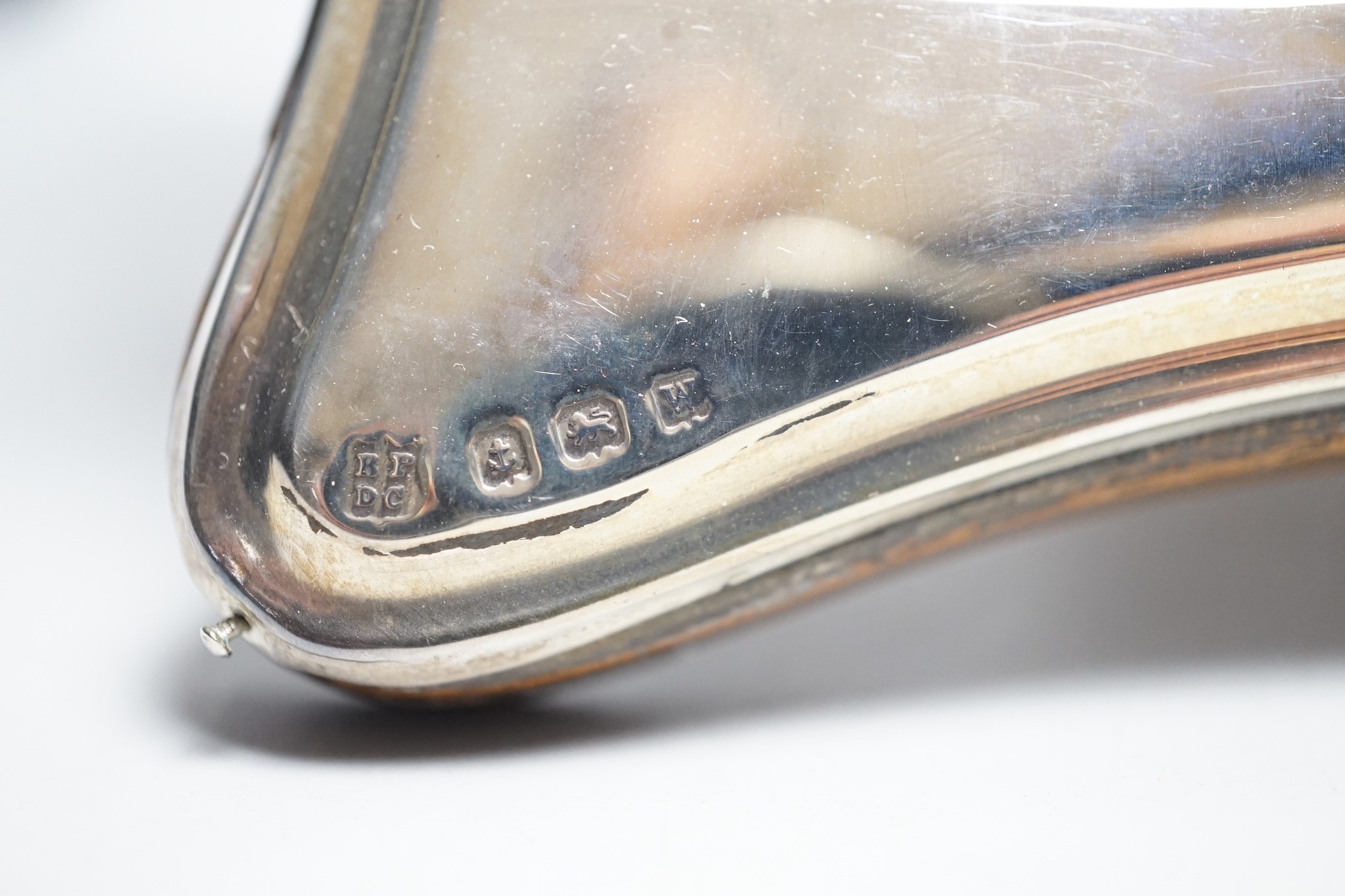 Two silver mounted photograph frames, including Edwardian with repousse border, Birmingham, 1909, 22.2cm.